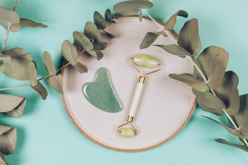Facial massage kit. Face roller and gua sha massager made from natural stones. © Anna Efetova