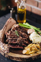 Rare filet mignon beefsteak with roasted potatoes, above view
