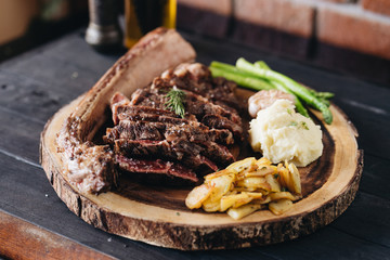 Rare filet mignon beefsteak with roasted potatoes, above view