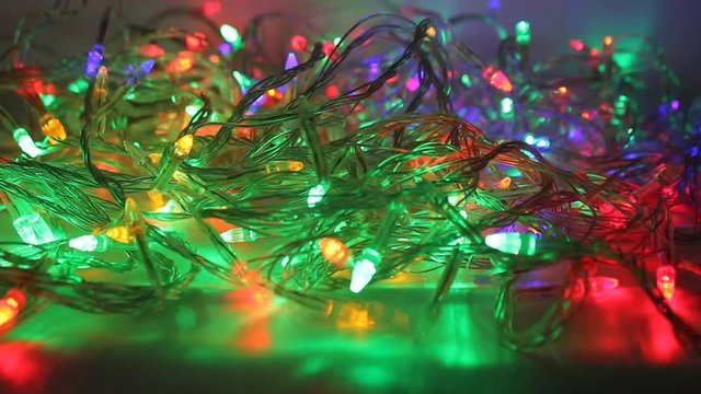 Colorful bokeh and christmas lights. New Year decoration. Abstract holiday background. Blinking garland. Christmas lights flicker.