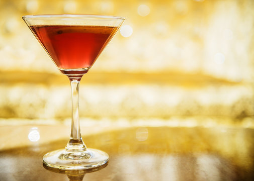Cosmopolitan cocktail on a gold background