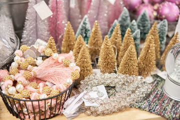 Small colorful Christmas trees. Lots of christmas decoration in store. Christmas shopping for new years tree. Christmas market