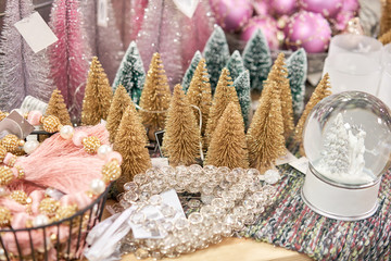 Small colorful Christmas trees. Lots of christmas decoration in store. Christmas shopping for new years tree. Christmas market