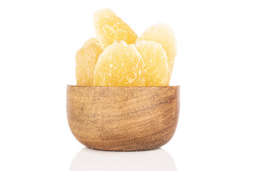 Lot of slices of dried yellow pineapple in bamboo bowl isolated on white background