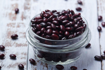 A bowl with red dry uncooked beans	