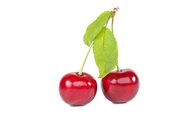 Sweet cherries with green leafs isolated on white background