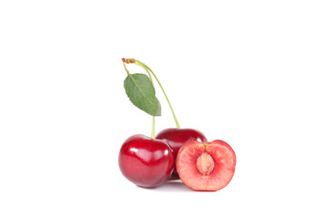 Sweet cherries with green leaf isolated on white background