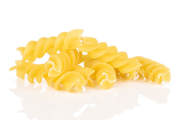 Lot of whole yellow pasta fusilli heap isolated on white background