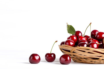 Sweet cherries in basket on white background