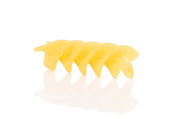 One whole yellow pasta fusilli isolated on white background