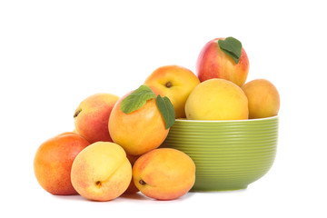Sweet apricots in bowl isolated on white background