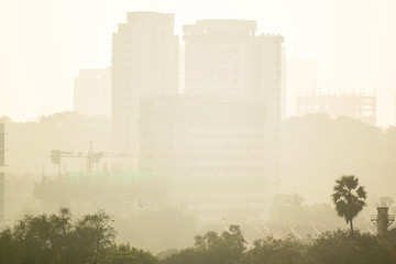 Fototapeta na wymiar High rises shrouded in haze and smog of air pollution in the suburb of Kandivali East in the city of Mumbai in India.