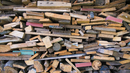 Multi-colored firewood with sticks for the stove.