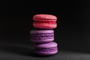 Multi-colored macaroons on a dark background. International Women's Day. French national cuisine. Food shot.