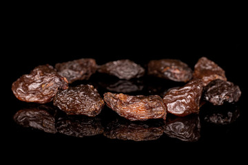 Lot of whole sweet dried dark raisin circle isolated on black glass