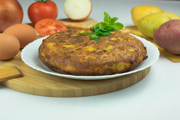 Spanish potato omelette accompanied by bread with tomato and typical Catalan oil with more ingredients