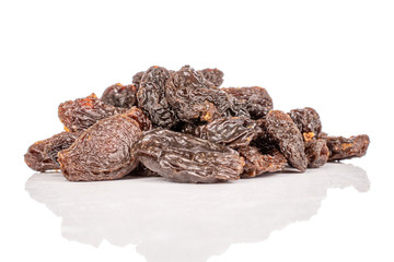 Lot of whole dried dark raisin stack isolated on white background