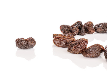 Lot of whole sweet dried dark raisin isolated on white background