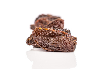 Lot of whole dried dark raisin in row isolated on white background