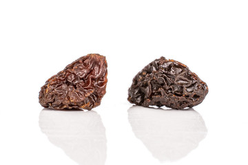 Group of two whole dried dark raisin isolated on white background
