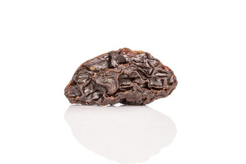 One whole dried dark raisin isolated on white background