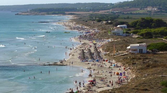 Aerial view of the "Son Bou" Beach, Balearic Islands.Time Lapse Panoramic with many people walking and the movement of waves, on the longest beach on the island of Menorca (municipality of Alaior), Sp