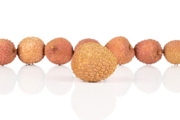 Group of eight whole fresh lychee one in focus isolated on white background
