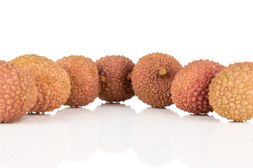 Group of seven whole fresh lychee isolated on white background