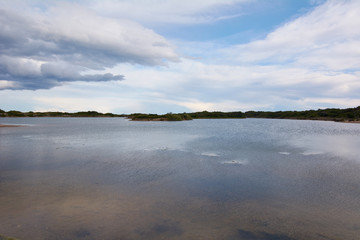 Dark clouds in sunset over the lake