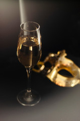carnival mask and champagne on a black background