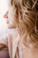 Obraz premium Blonde girl's curl close-up, soft focus