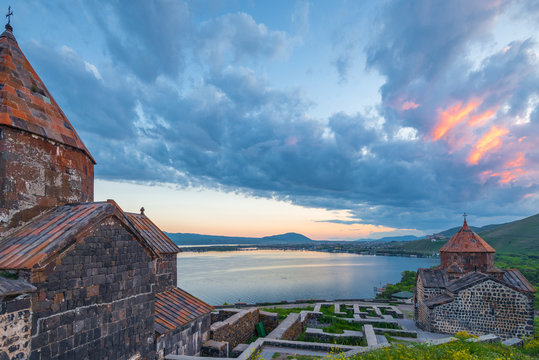 The buildings of Sevanavank monastery at sunset are a landmark of Armenia under a dramatic sky