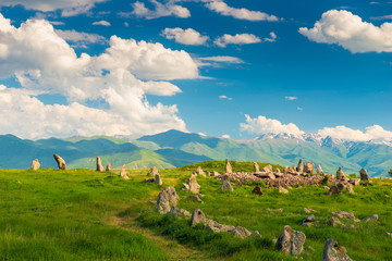 Stones of Zorats Karer in Karaunja on the background of the beautiful mountains of Armenia, summer...