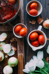 Dyeing eggs for Easter holidays, coloring with different color and tonality using natural food dye pigment and painting color, over a white  background, chocolate eggs , top view, flatlay,soft light