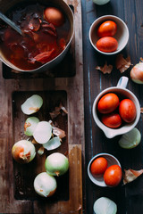 Dyeing eggs for Easter holidays, coloring with different color and tonality using natural food dye pigment and painting color, over a white  background, chocolate eggs , top view, flatlay,soft light