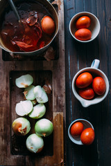 Dyeing eggs for Easter holidays, coloring with different color and tonality using natural food dye pigment and painting color, over a white  background, chocolate eggs , top view, flatlay,soft light