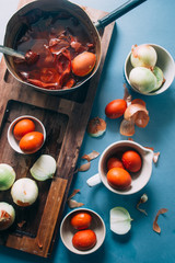 Dyeing eggs for Easter holidays, coloring with different color and tonality using natural food dye pigment and painting color, over a white  background, chocolate eggs , top view, flatlay,soft light