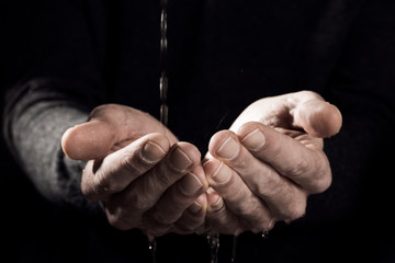 male hands catching water