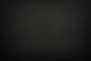 Black matte paper texture background. Surface of abstract dark texture. Gray blank page background flat close up view.