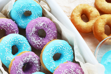 multicolored donuts in a basket with icing, top view, side view