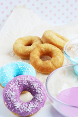 multicolored donuts in a basket with icing, top view, side view