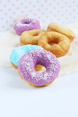 multicolored donuts in a basket with icing, top view, side view