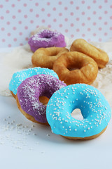 multicolored donuts in a basket with icing, top view, side view