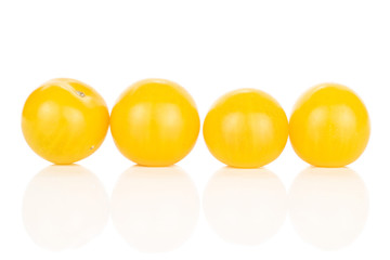 Group of four whole fresh yellow tomato line isolated on white background