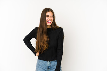 Obraz premium Young caucasian woman isolated on white background laughs and closes eyes, feels relaxed and happy.