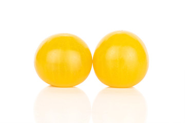 Group of two whole fresh yellow tomato isolated on white background
