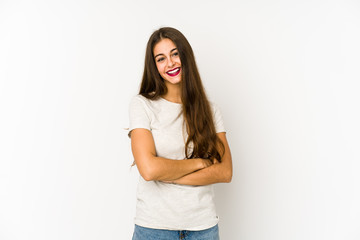 Young caucasian woman isolated on white background who feels confident, crossing arms with determination.