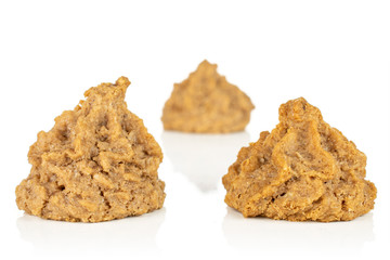 Group of three whole homemade brown coconut biscuit with chocolate front focus isolated on white background