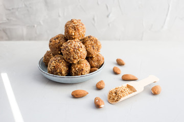 energy balls in walnut chips on a light background