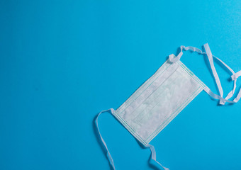 Fototapeta na wymiar Protective face mask - surgical mask - on blue background